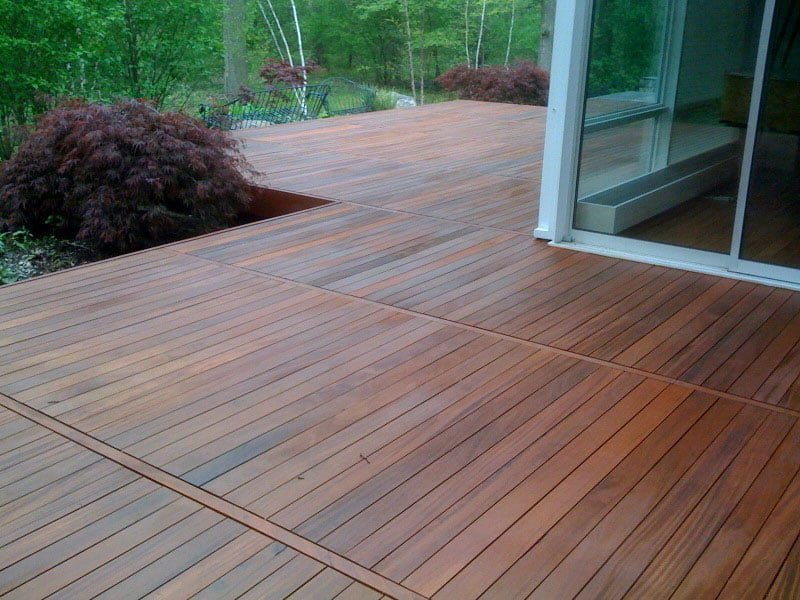 A close-up view of a wooden deck treated with high quality semi transparent deck stain.