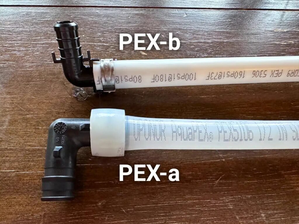 Coils of red and blue PEX tubing displayed on a workshop table for comparison.