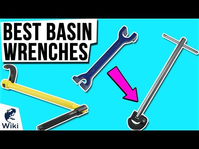 A collection of professional plumbing tools including various basin wrenches on a wooden workbench.