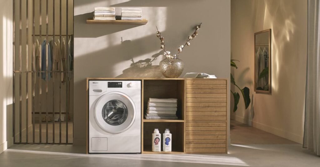A compact dryer in a modern small apartment laundry space with soft natural lighting.