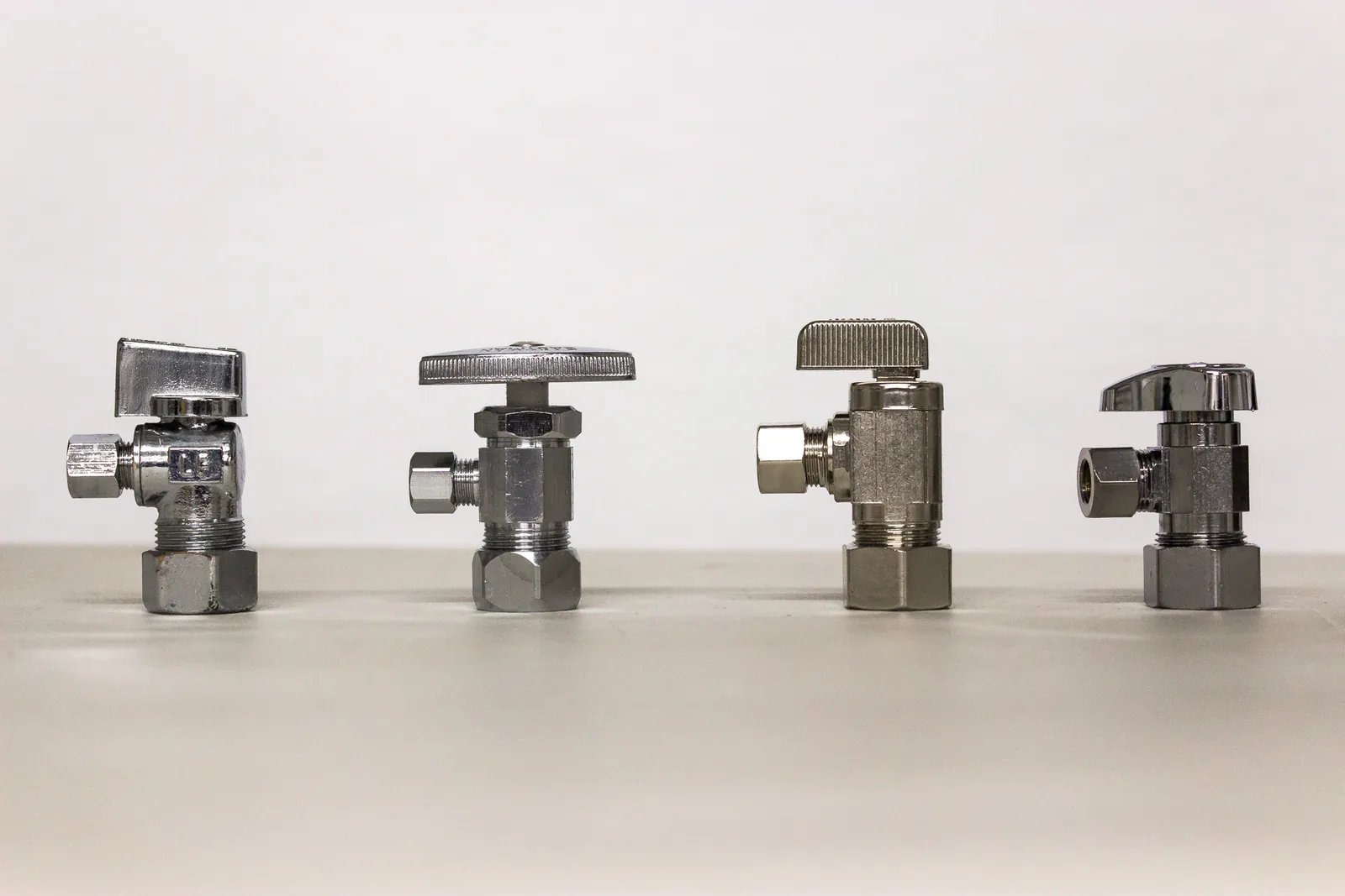 Comparison between a brass ball valve and a plastic multi-turn angle stop valve.