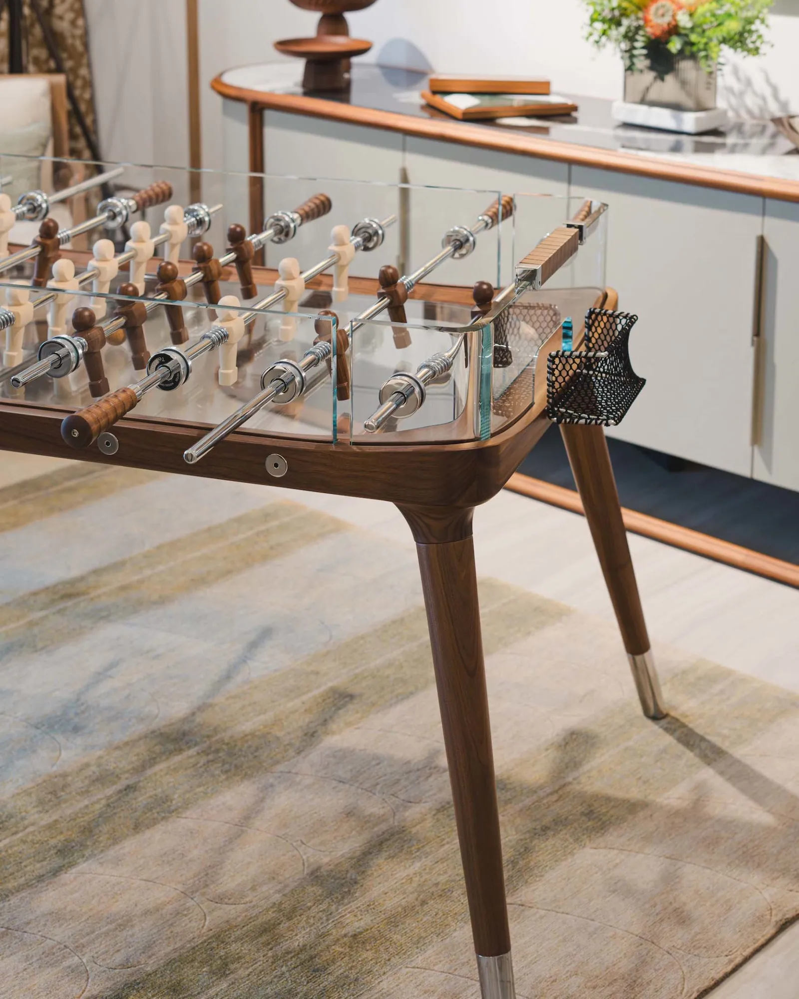 Comparison of three different sized foosball tables on a clean floor