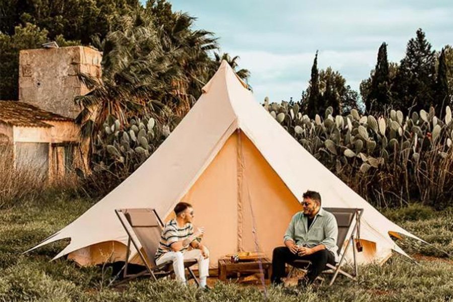 Cozy teepee tent in a forest clearing at golden hour with natural soft light