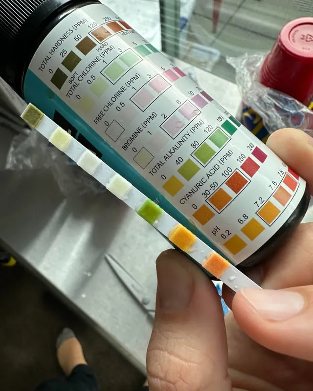 Crusty bromine tablet on a saucer next to a low reading thermometer.