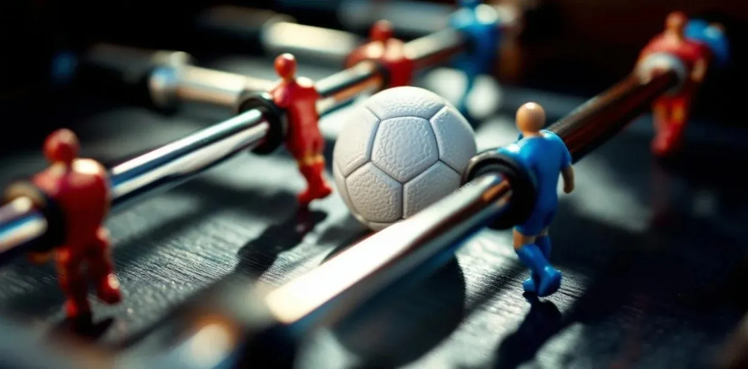 Defender gripping foosball rod tightly to adjust strategy during a match