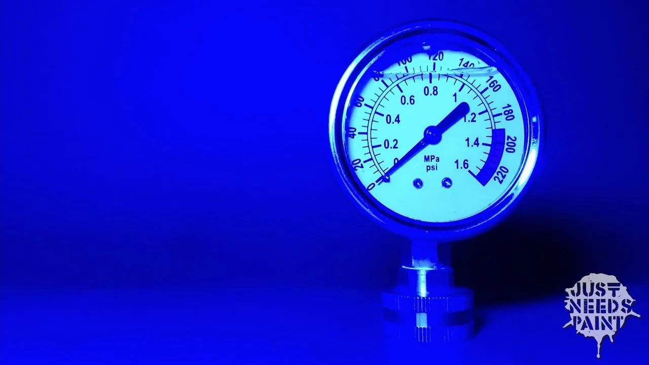 A detailed view of a water pressure gauge showing the maximum pressure indicator.