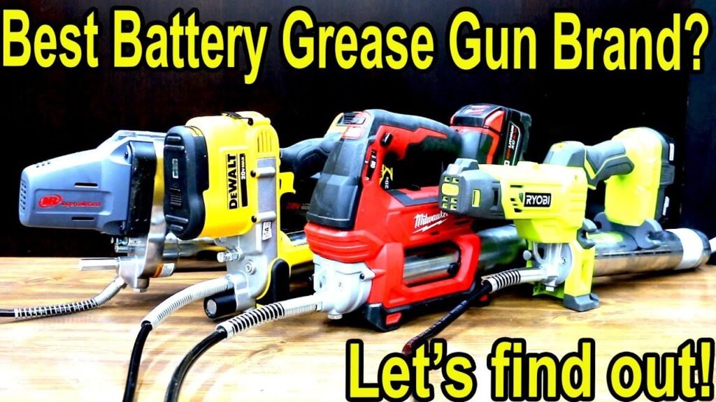 DeWalt and Milwaukee cordless grease guns sitting side by side on a workbench.