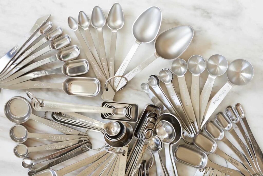 Digital measuring spoons on a marble counter with soft natural lighting