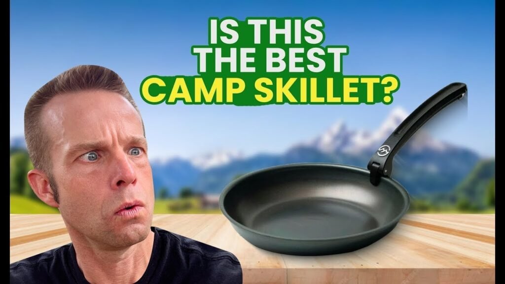 A durable camping frying pan rests on a portable stove in a quiet forest.