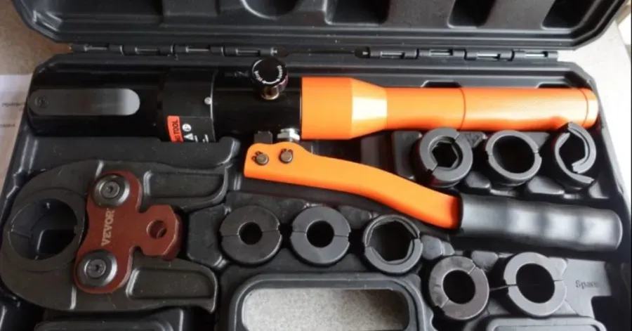 A durable steel wrench resting on a canvas bag for storing plumbing tools.