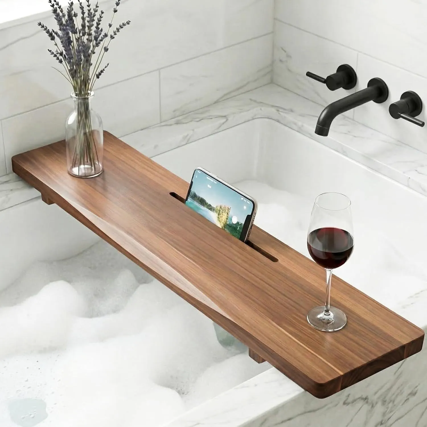 An expandable bamboo bathtub caddy with a tablet stand holds an e-reader securely.