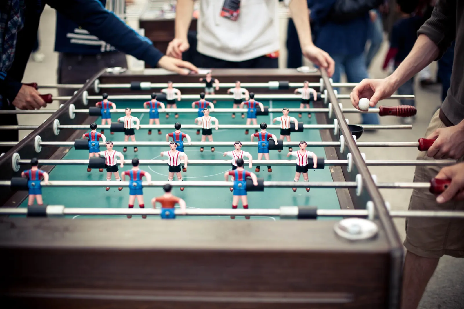 Foam and plastic foosball balls on a green table surface