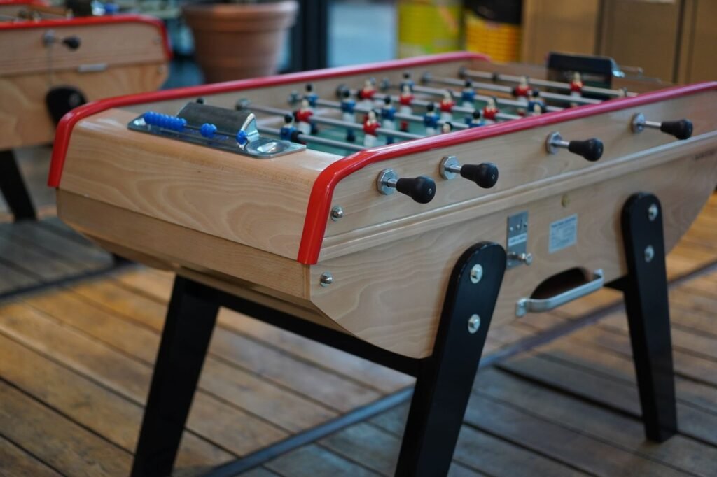 Full size foosball table standing in a bright modern living room