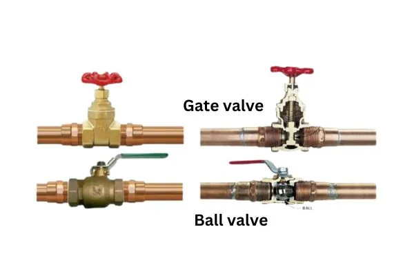 A hand turning the circular wheel of an industrial gate valve.