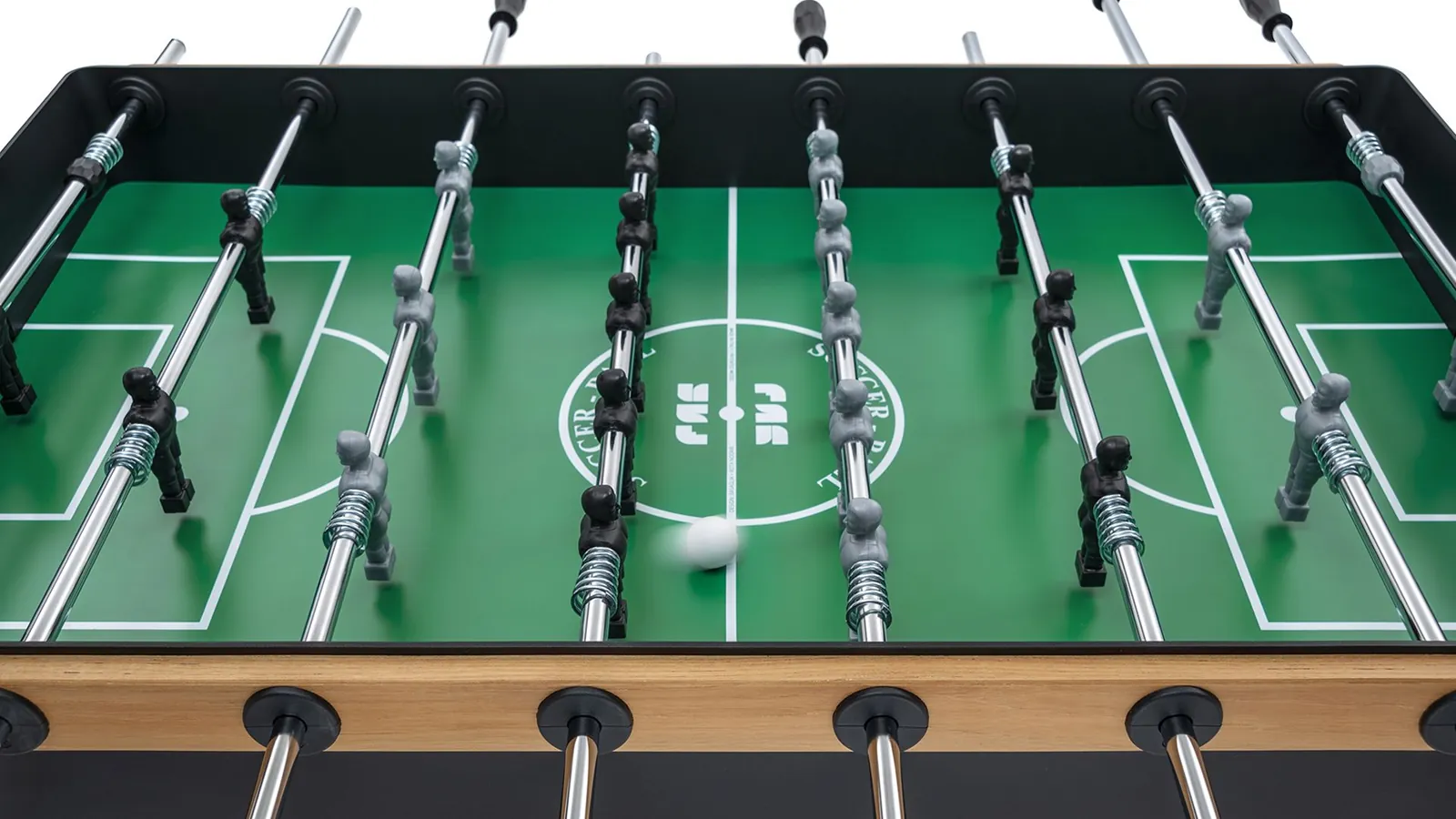 Hands adjusting foosball table leg levelers for proper balance