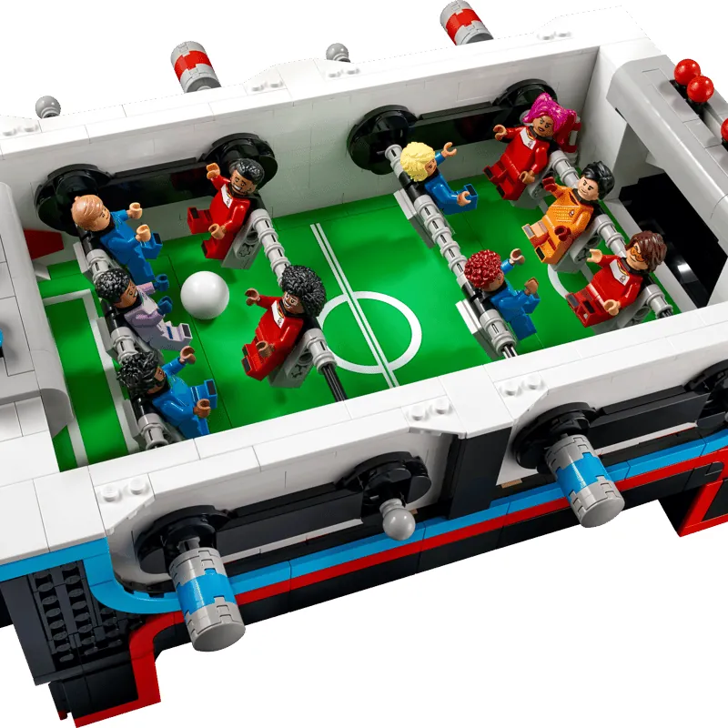 Hands adjusting a lego foosball rod to fix loose connections and friction.