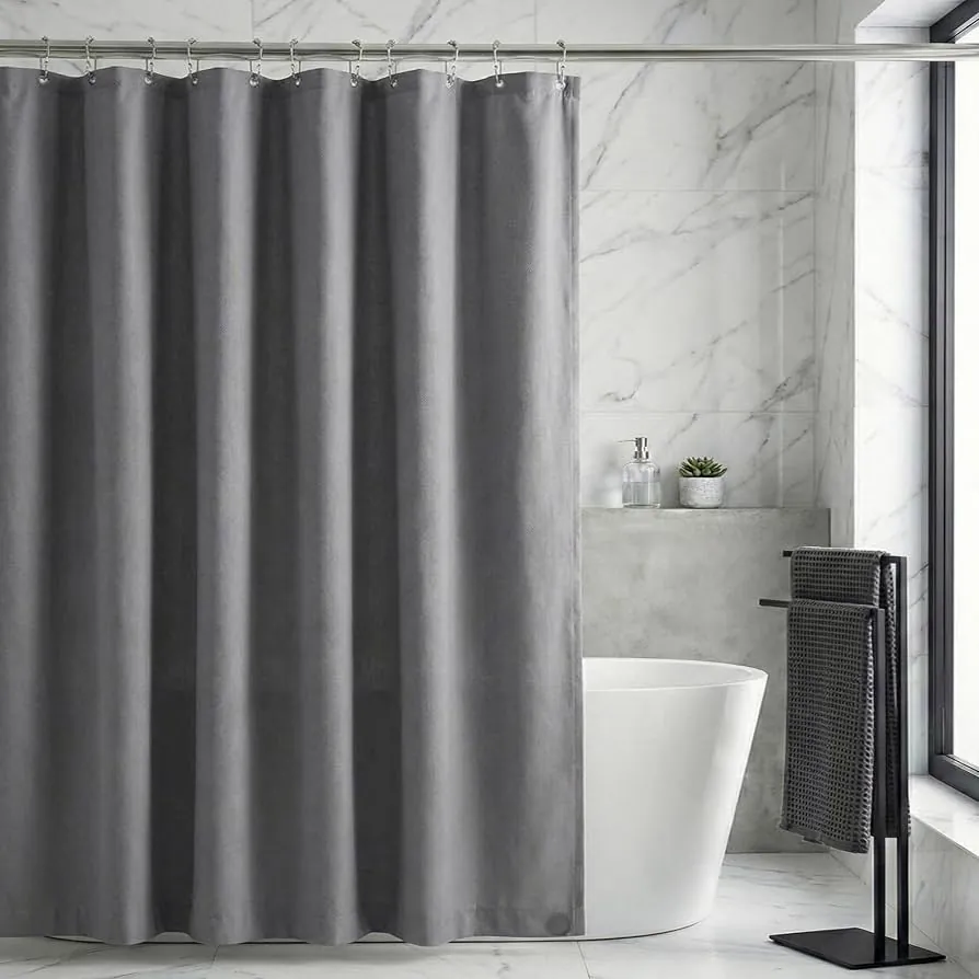 Hands attaching a fabric shower curtain liner to a metal shower rod.