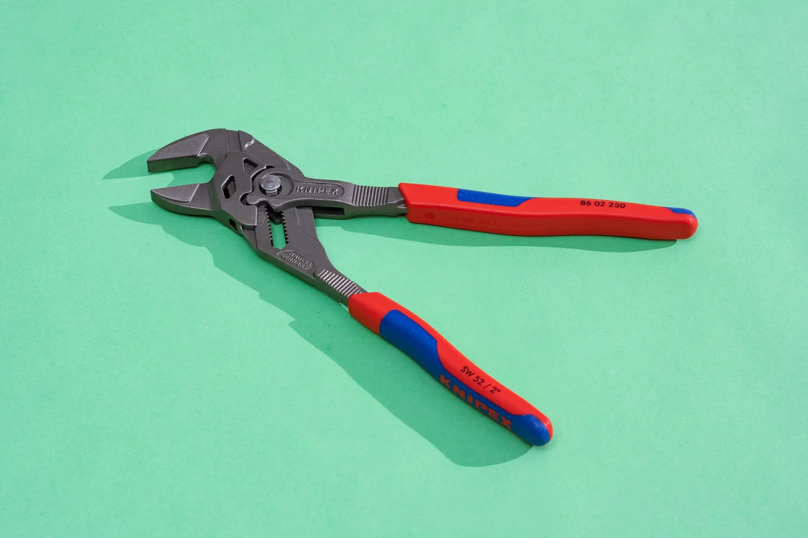 Hands operating a modern push-button quick-adjust tongue and groove plier.
