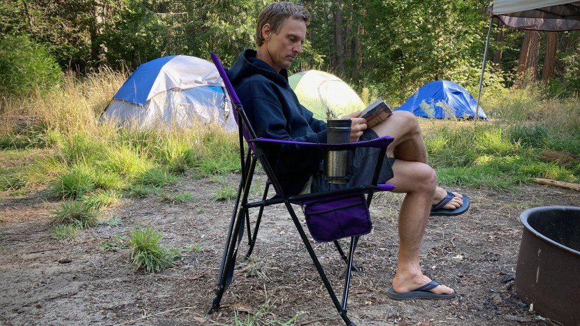 heavy-duty camping chair on a grassy hillside at dusk