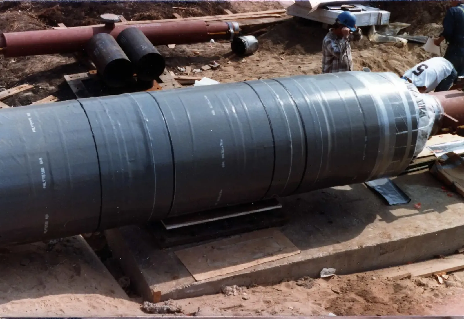 High-temperature mineral wool insulation wrapped tightly around an industrial steam pipe.