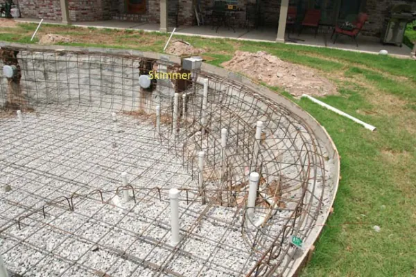Homeowner inspecting a single skimmer on a small rectangular pool.