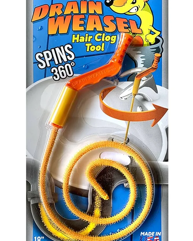 A kitchen sink drain showing signs of debris with cleaning tools nearby.