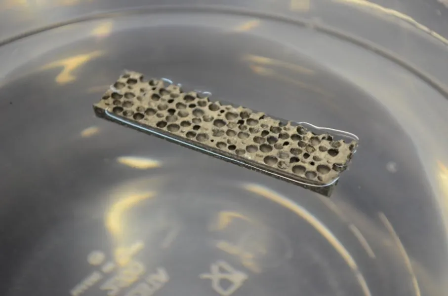 Lead fishing weight floating on water surface due to air film effect.