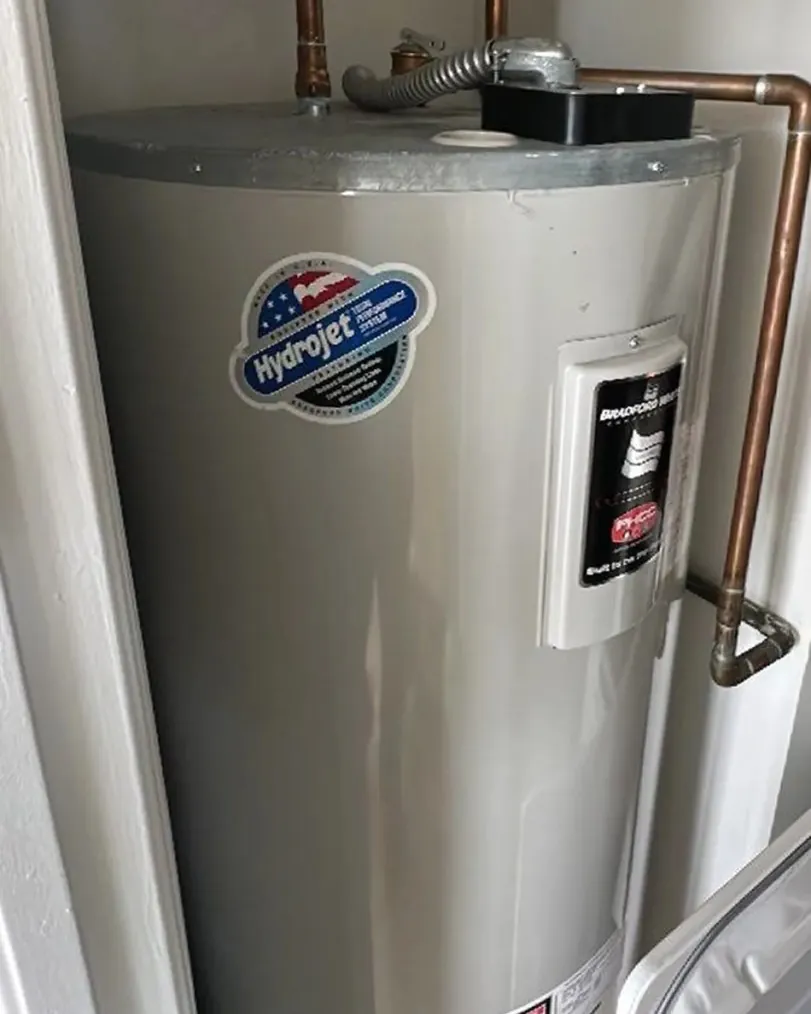 A main water shut-off valve on copper pipes before a water heater installation.
