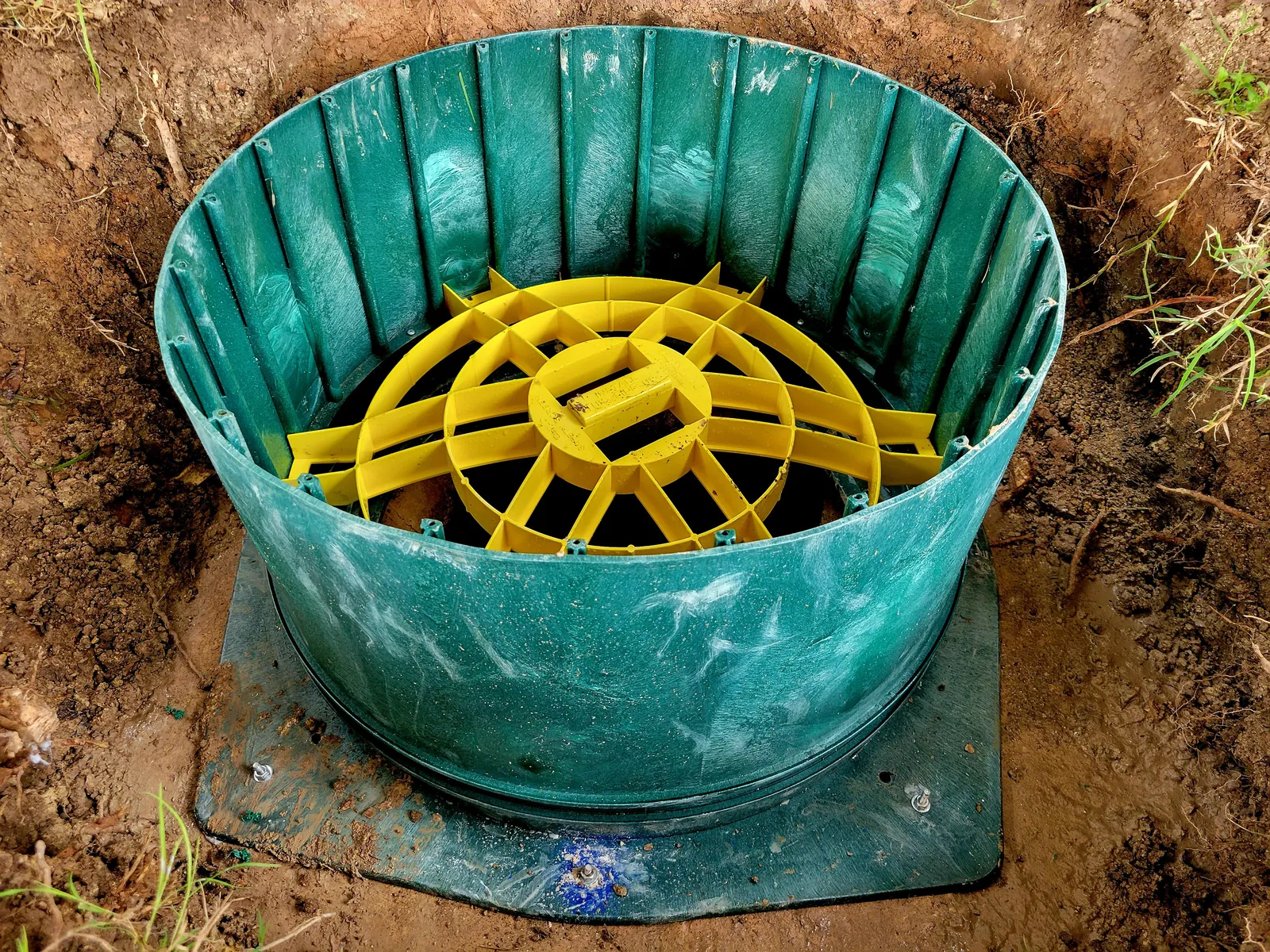 Measuring the diameter of a septic tank opening for a riser kit.