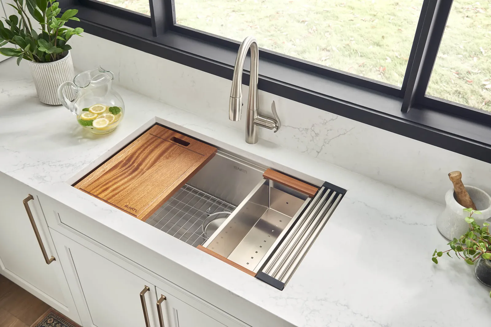 Measuring the inside of a kitchen cabinet base to determine correct sink size.