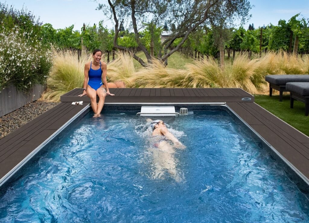 modern endless pool in a backyard with a clear sky and minimalist landscaping