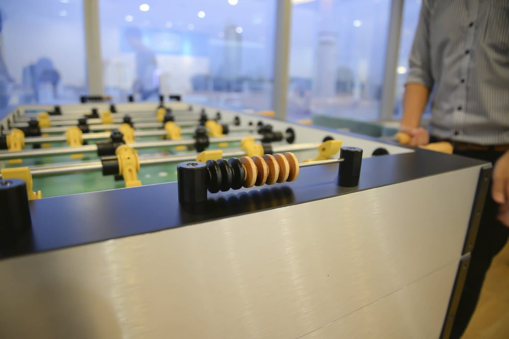 Modern foosball table in a bright, contemporary office setting.