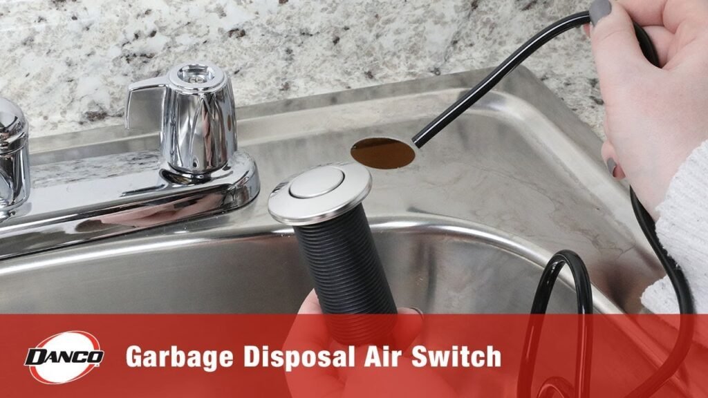 A modern garbage disposal air switch installed on a clean kitchen countertop.