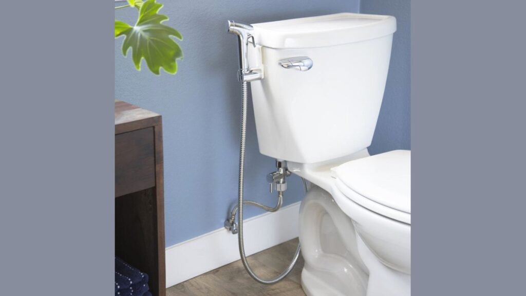 A modern handheld bidet sprayer installed in a clean, minimalist bathroom setting.