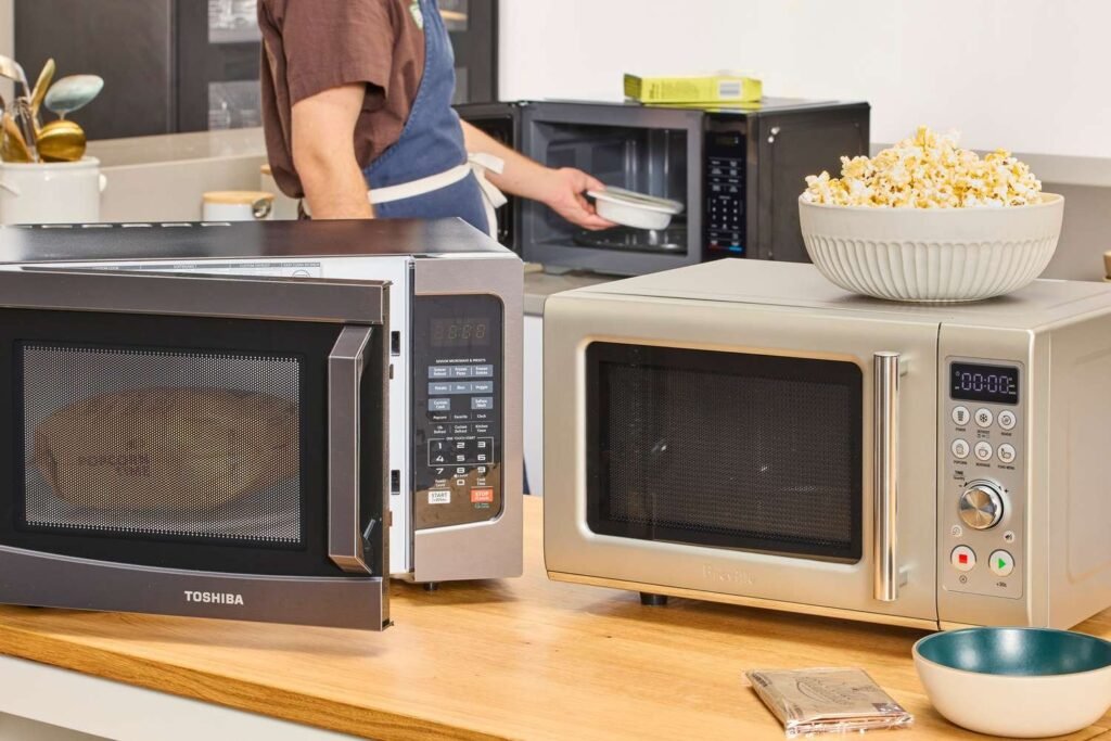 Modern microwave on a countertop with soft light and minimal décor