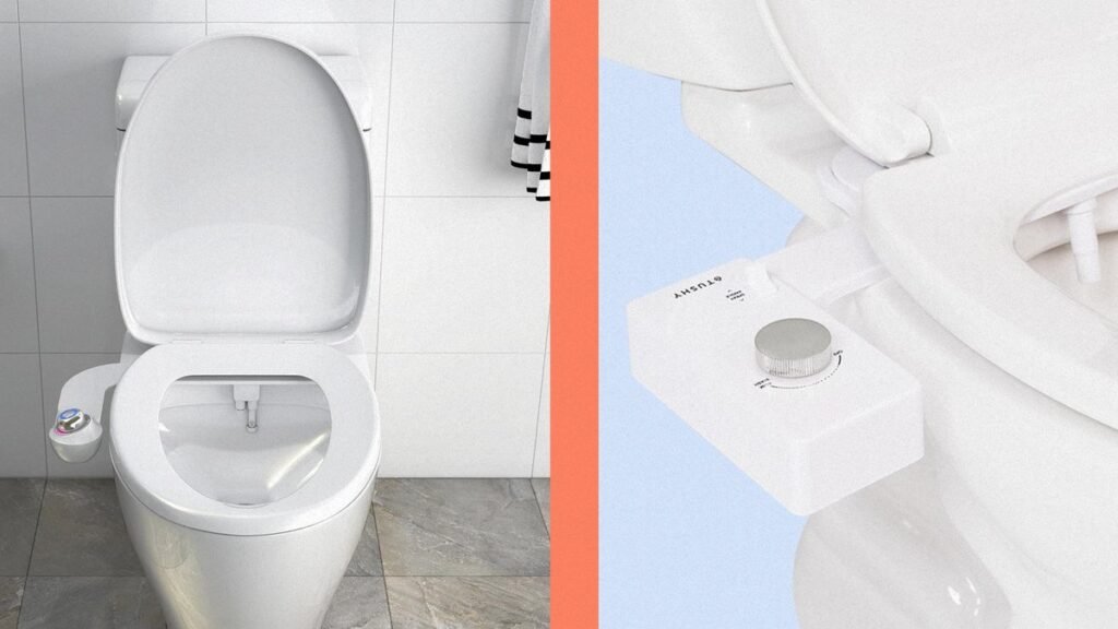 Modern white bidet attachment installed on a clean bathroom toilet bowl.