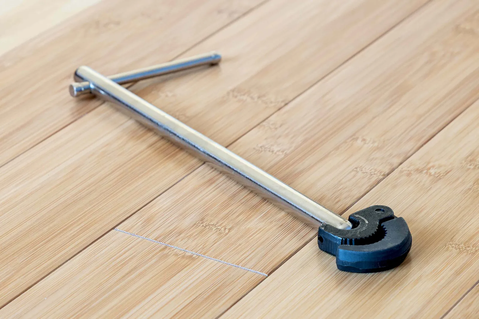 A multi-head basin wrench being held to show its various nut-fitting slots.