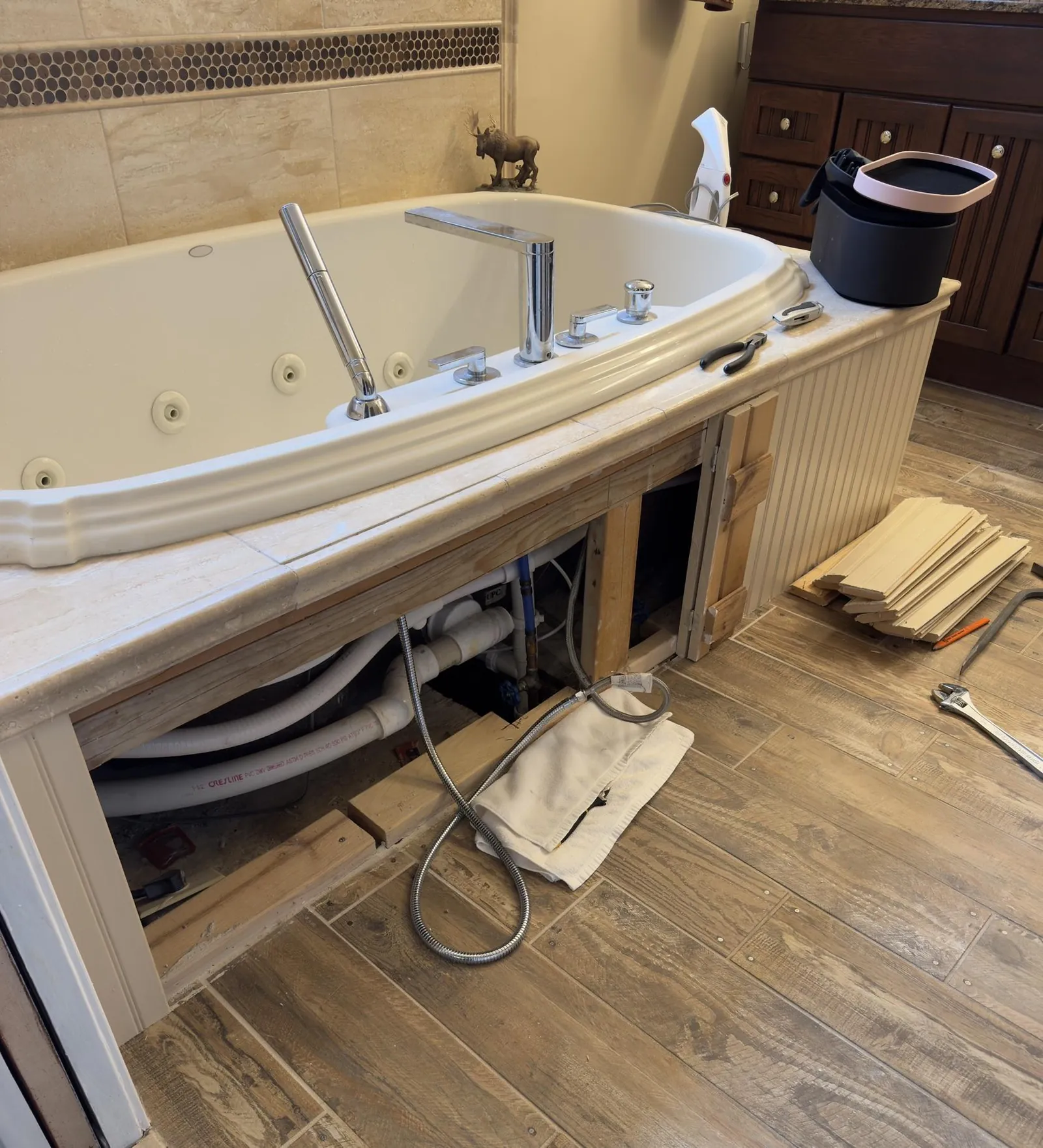 Open hot tub cabinet showing severe water damage requiring professional repair instead of DIY.