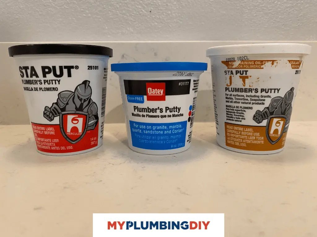An open tub of plumbers putty sits next to plumbing tools on a workbench.