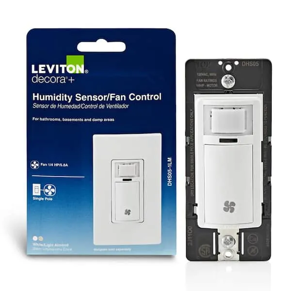 Person adjusting the sensitivity dial on a bathroom humidity sensor switch.