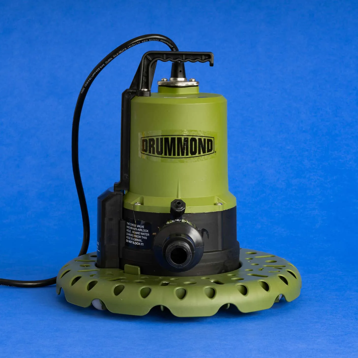 A person evaluating a sump pit location to choose the best utility pump.