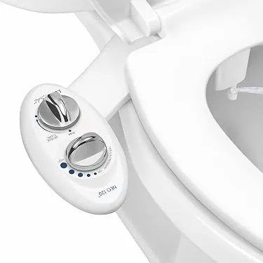 Person measuring the distance between a toilet and sink for bidet installation.