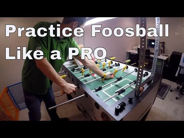 Player hands gripping foosball table rods during a focused practice session
