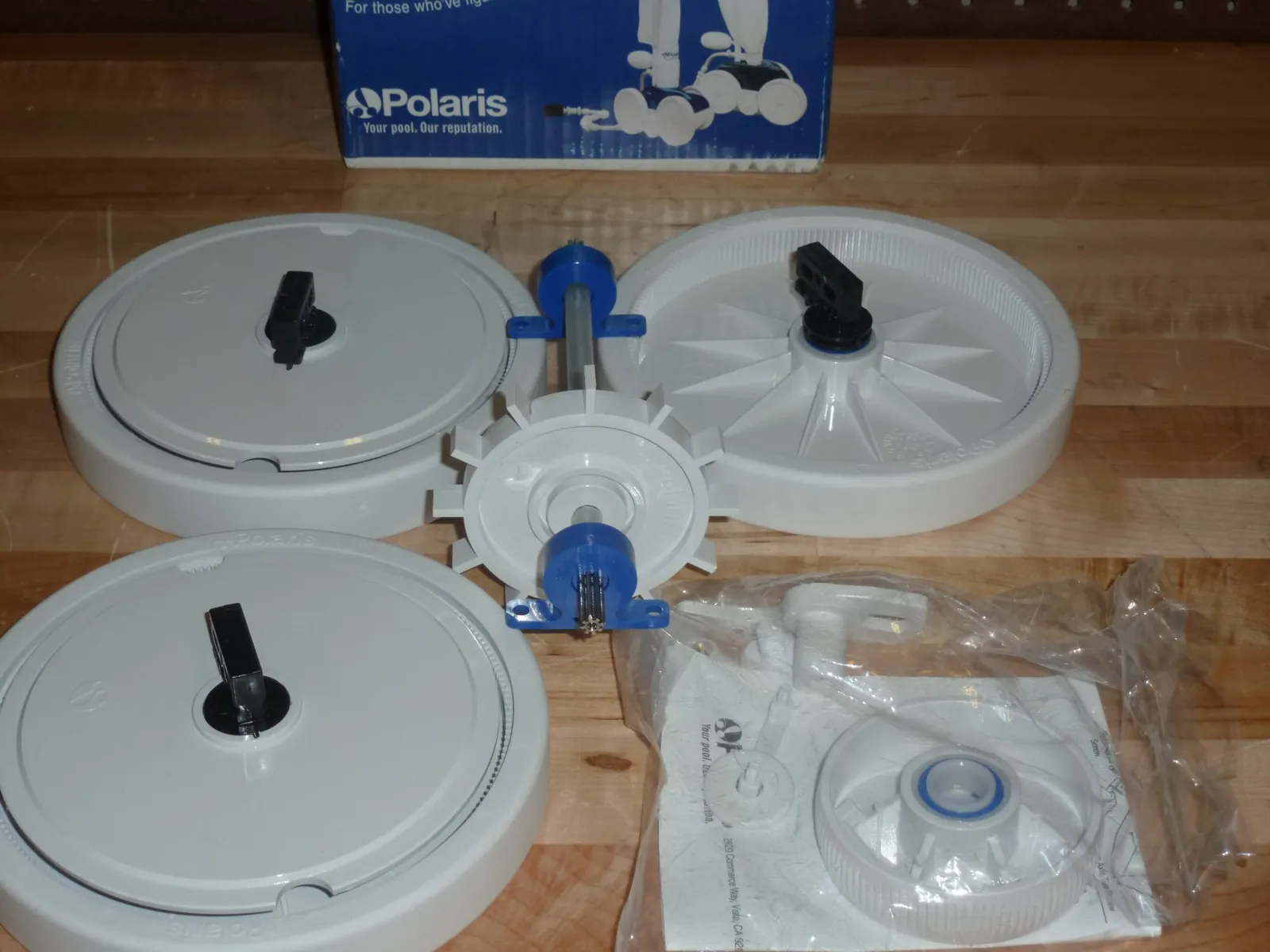Pool cleaner wheel hovering over stained floor due to height setting error.