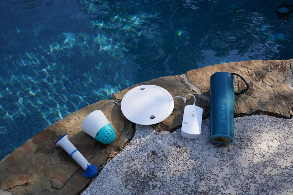 Pool water testing tools and calibration equipment arranged on an outdoor stone table
