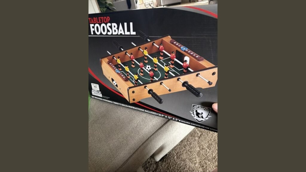 Premium foosball accessories like rods and chalk arranged on a table.