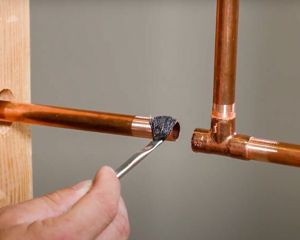A professional plumbing soldering kit arranged neatly on a clean workbench for home repairs.