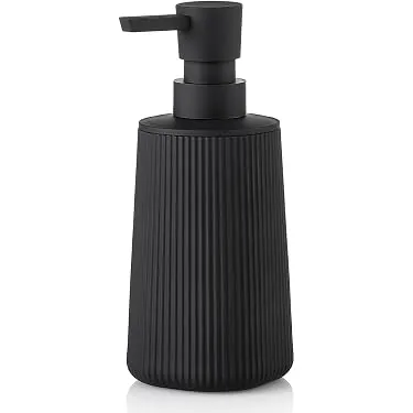 Refilling a bathroom soap dispenser carefully using a funnel to avoid spills.