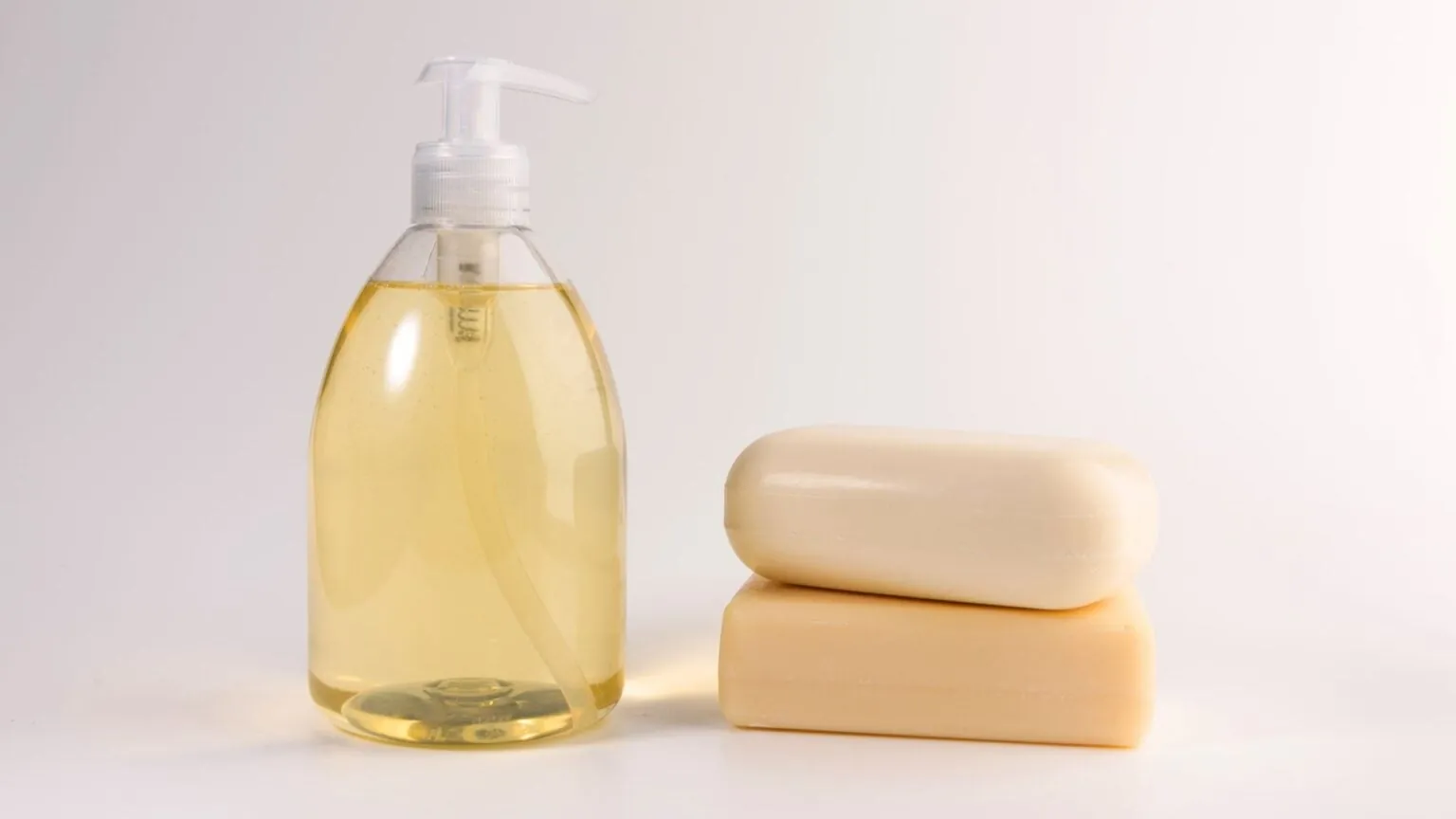 Refilling a manual soap dispenser with liquid soap from a pouch.