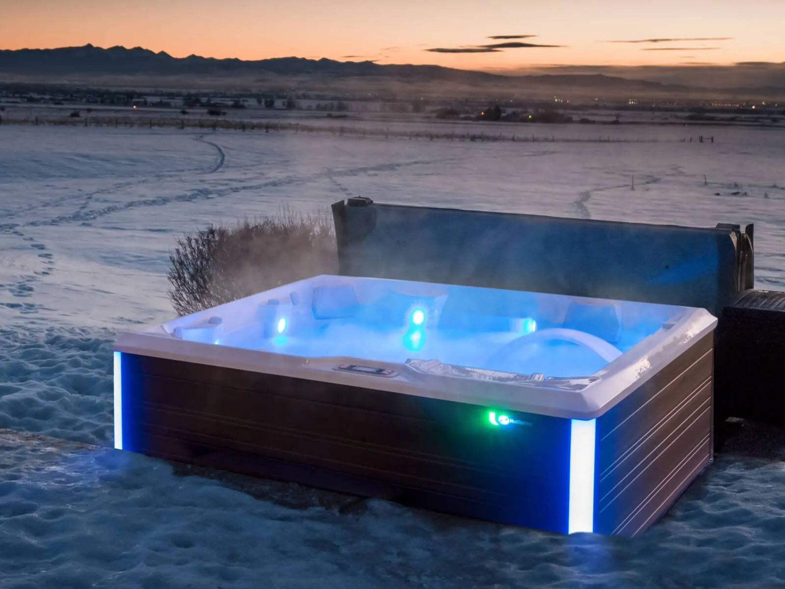 Running hot tub with steam in snowy winter conditions
